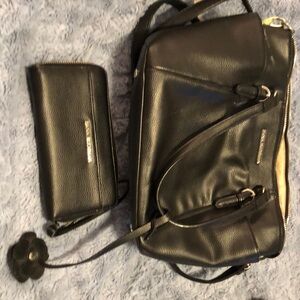 ￼Dana Buchma black bag With matching wallet used very little .